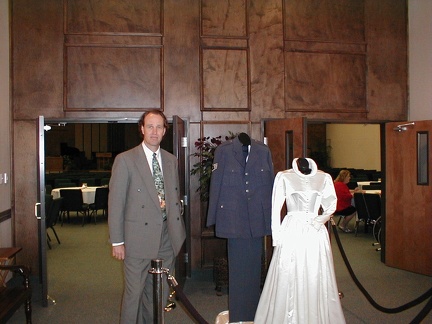 Randy next to Uniform and Wedding Dress